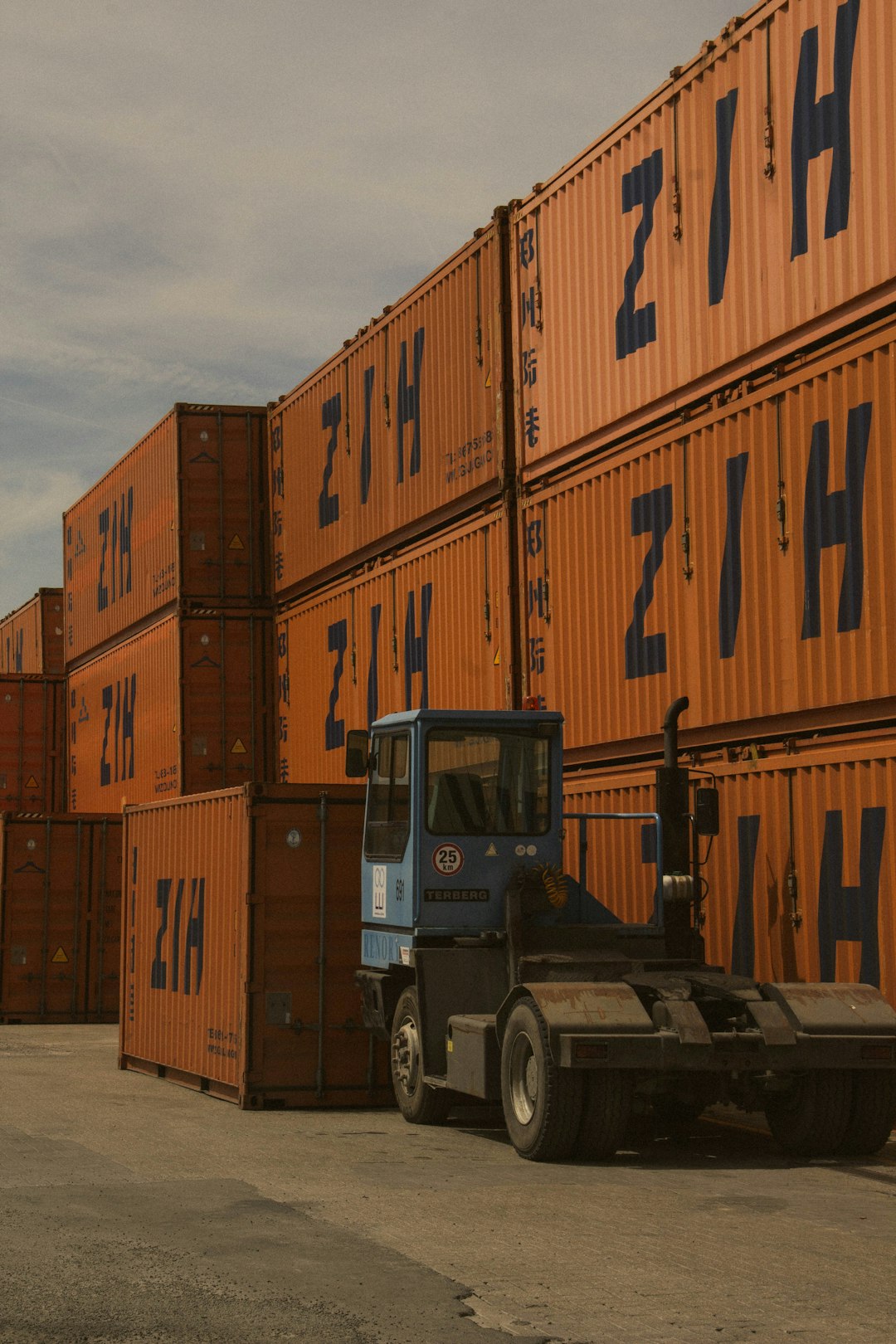 services-04 a-forklift-parked-in-front-of-a-large-stack-of-shipping-containers-0dhrdqk2dwo